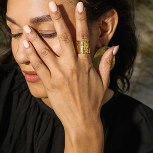 The ring is designed as a cuff-style piece that wraps around the finger.