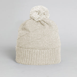 Off white pom pom beanie for kids ethically made by fair trade knitters.