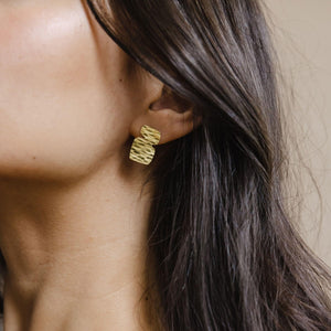 Midcentury modern brass earrings shaped by stacking stones by Mulxiply.