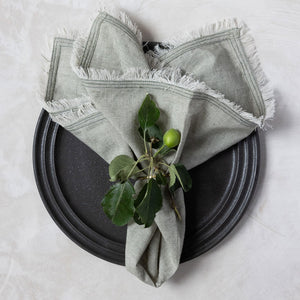 Fringe edge olive and white weave napkin by Mulxiply and Campfire Pottery in Portland, Maine