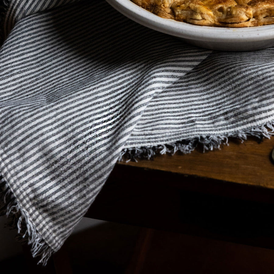 Handwoven fringe edge napkin in black and white stripe by Mulxiply and Campfire Pottery for Ember Maine