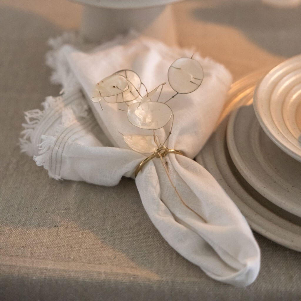 Natural white fringe-edge cotton napkin by Mulxiply and Campfire Pottery