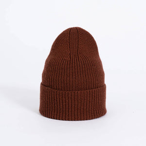 Rust red winter hat in soft itch-free wool. Crafted in Nepal.