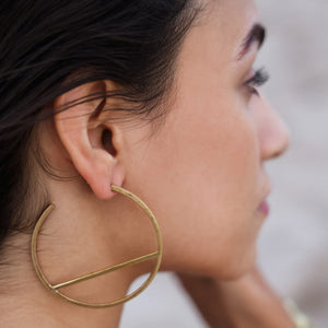 Modern hoop earrings in brass. The earrings are crafted from brass and have a sleek and contemporary design
