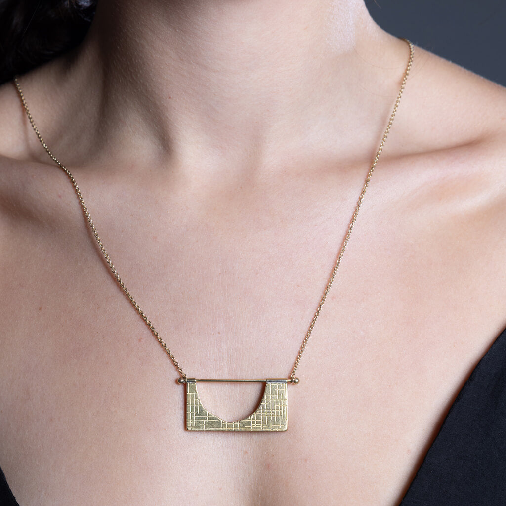 Mid-century modern hatch imprint necklace in Brass by Mulxiply