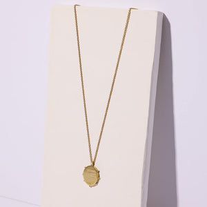 Smooth oval necklace with delicate orbs for layering.