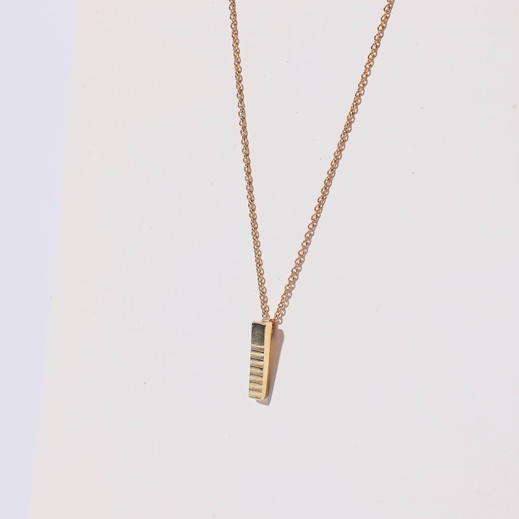 Brass, stick charm necklace. Ethically made in Nepal