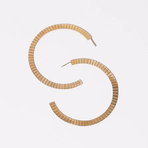 Modern, linear hoop earrings in brass by Mulxiply