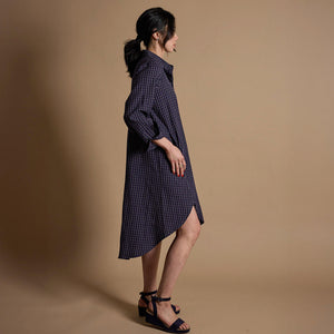 Woman wearing a navy shirtdress, ethically made by Mulxiply.