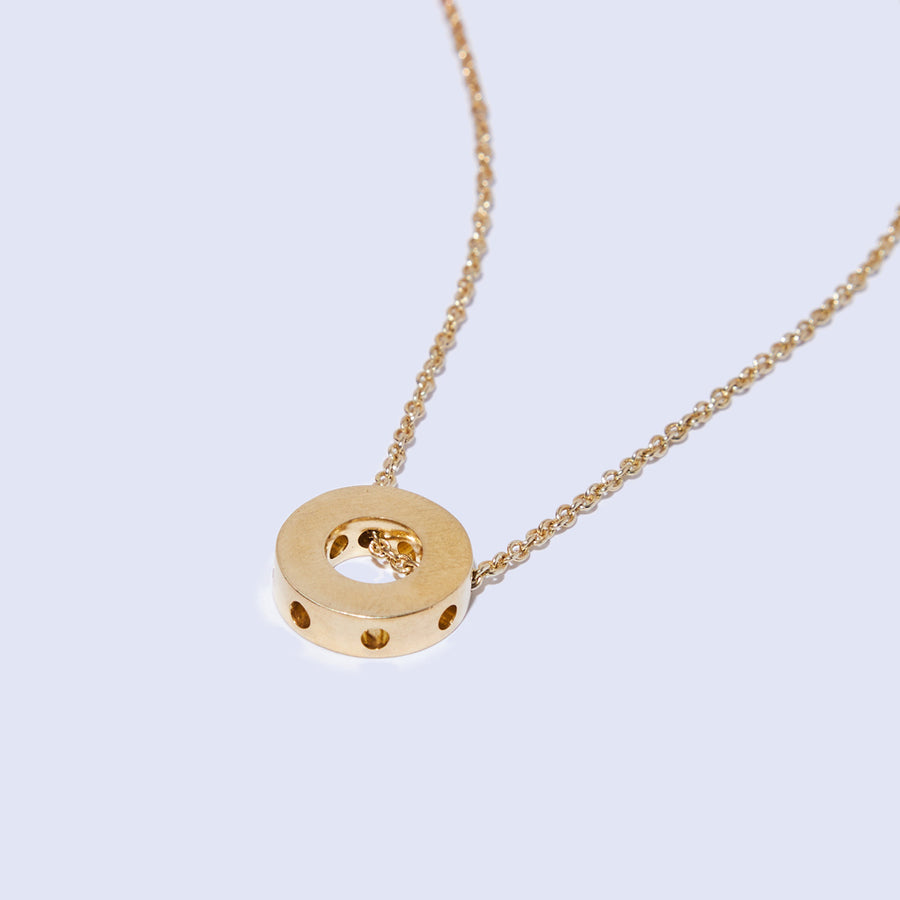 Simple wheel design necklace on a dainty chain