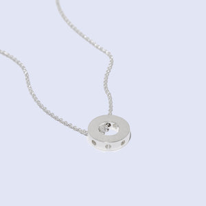 Sterling Silver Circle Wheel Necklace suspended on a dainty chain