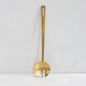 Long brass serving fork by Ember. Collaboratively made by Mulxiply and Campfire Pottery.