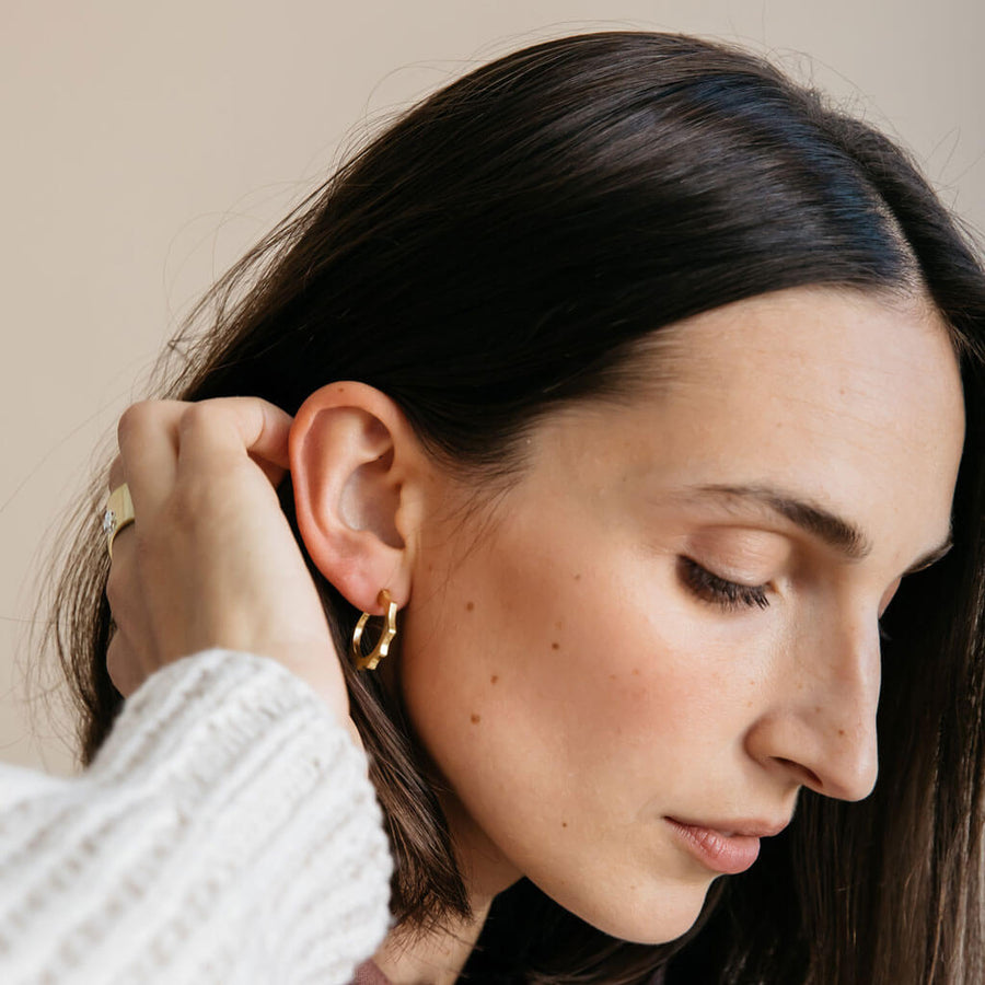 Small and mighty brass hoop earrings with a little edge.