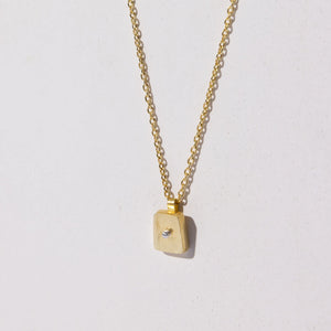 Delicate charm necklace with brass and sterling charm by Mulxiply.