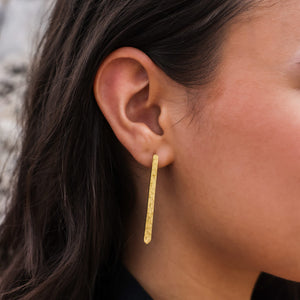Long stick earrings in hammered brass by Mulxiply