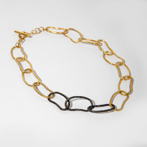 Mixed metals and bold links make this necklace a coveted staple.