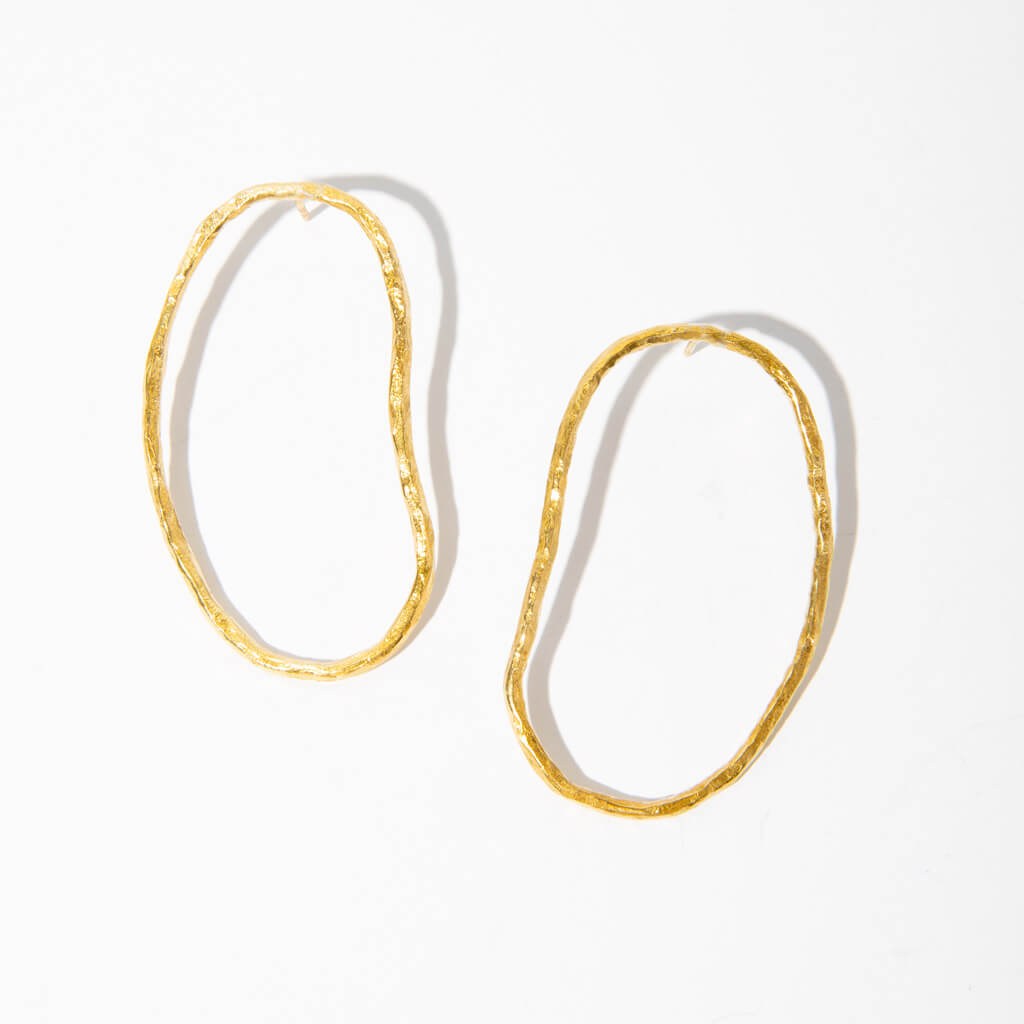 Organic pool shaped statement earrings in brass.