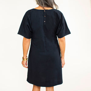 Hand carved coconut buttons add a special touch to this handmade black shift dress.