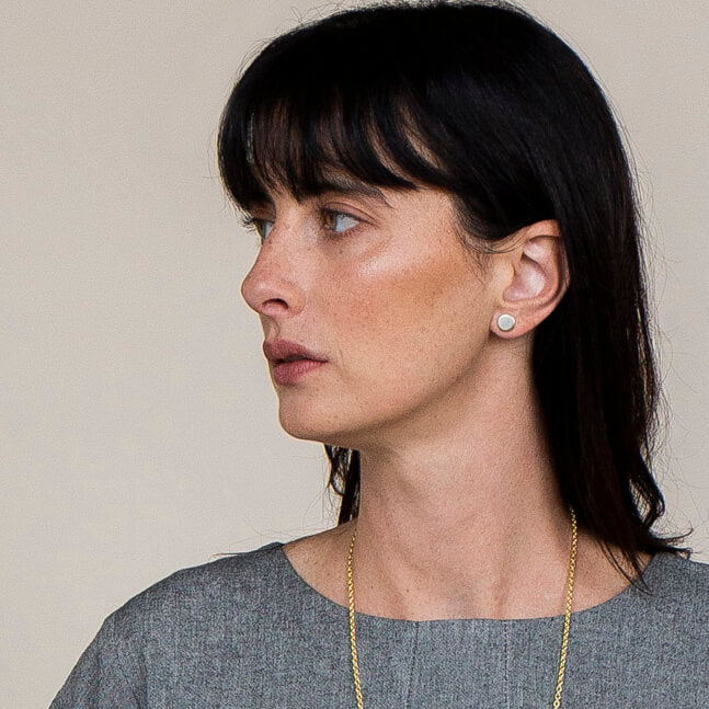 Our circle sterling silver stud earrings are an ode to mismatched minimalism