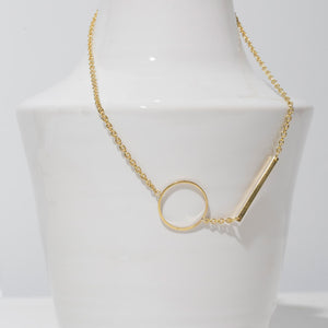 Simple gold chain with circle and line design.