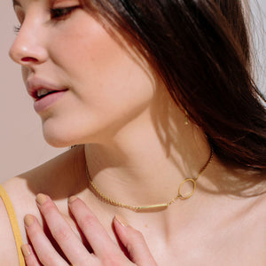 Minimal layering necklace in gold.