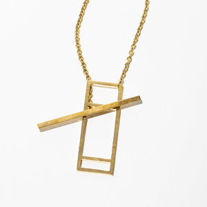 The necklace features a long, thin chain made of brass, with a unique window-shaped pendant at the end. 